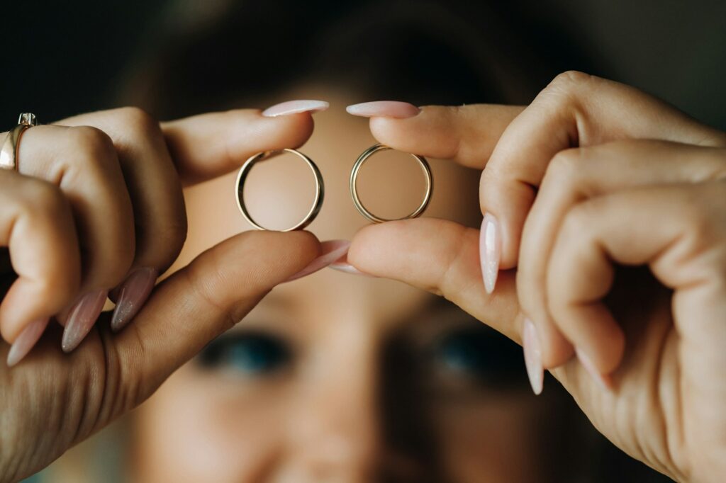 Close-up of two gold wedding rings in your hands