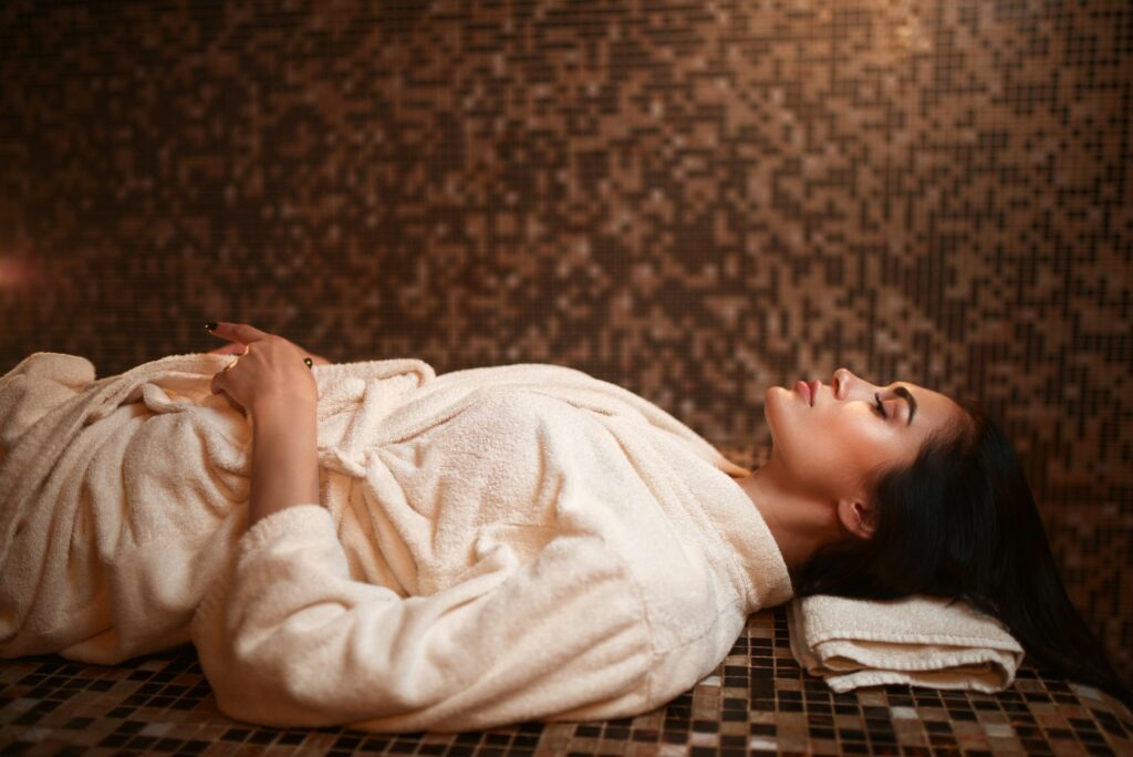 Woman lying on a hot stone, turkish hamam, sauna